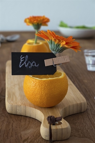 Tafeldecoratie met Gerbera's en sinaasappels.